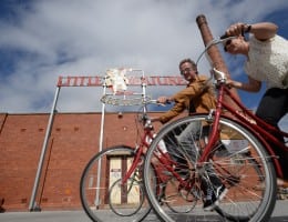 People on bikes in front of factory